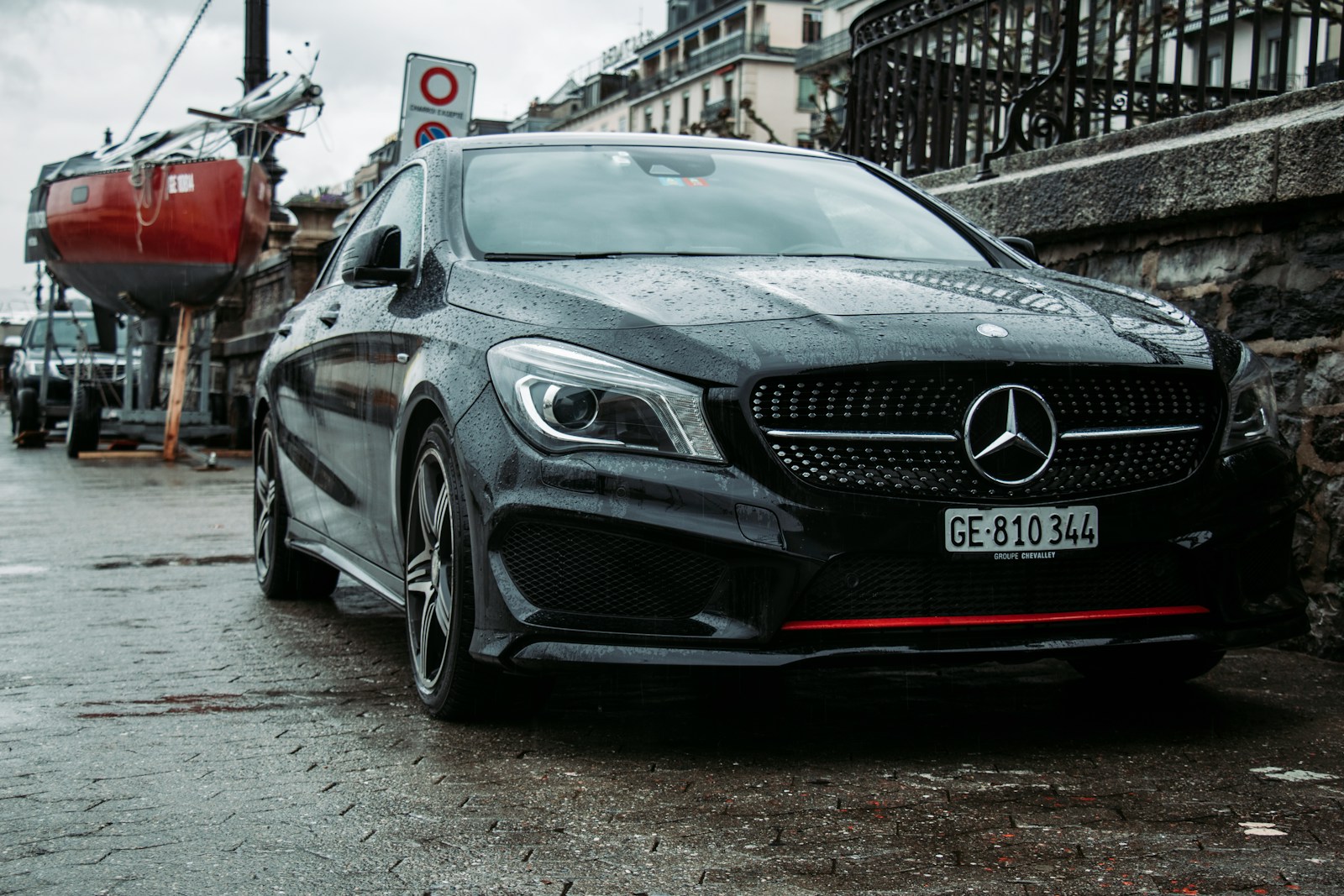 a black mercedes cla parked on the side of the road