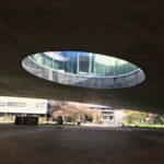people walking on gray concrete pavement near gray building during daytime