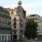 A river running through a city next to tall buildings