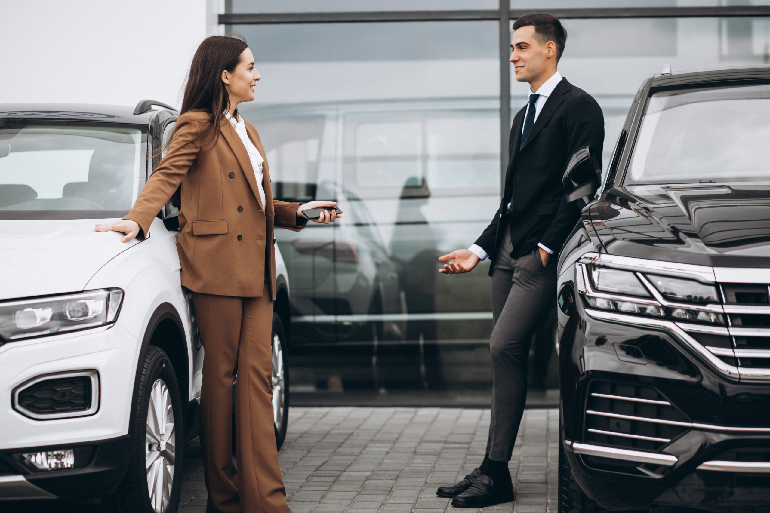 young couple choosing car car showroom scaled
